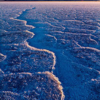 I was on my way to California and happened to be driving through the salt flats of Utah's west desert at sunset. I pulled off the freeway and just walked out onto the flats until I found this line leading me to the horizon. 